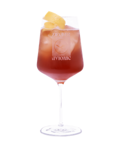 Ein ansprechendes Getränk in einem hohen Glas, gefüllt mit Eis und einem fruchtigen Cocktail, dekoriert mit Zitronenstücken.