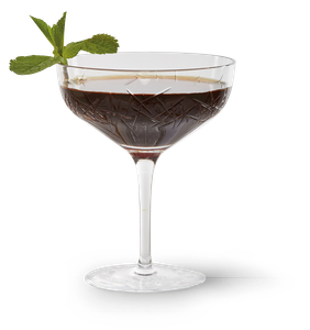 Ein elegantes Cocktailglas mit dunklem Getränk und frischer Minze, das auf einem weißen Hintergrund präsentiert wird.