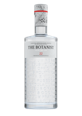 Eine elegante Flasche mit dem Etikett 'The Botanist Islay Dry Gin', verziert mit botanischen Namen auf der Oberfläche.